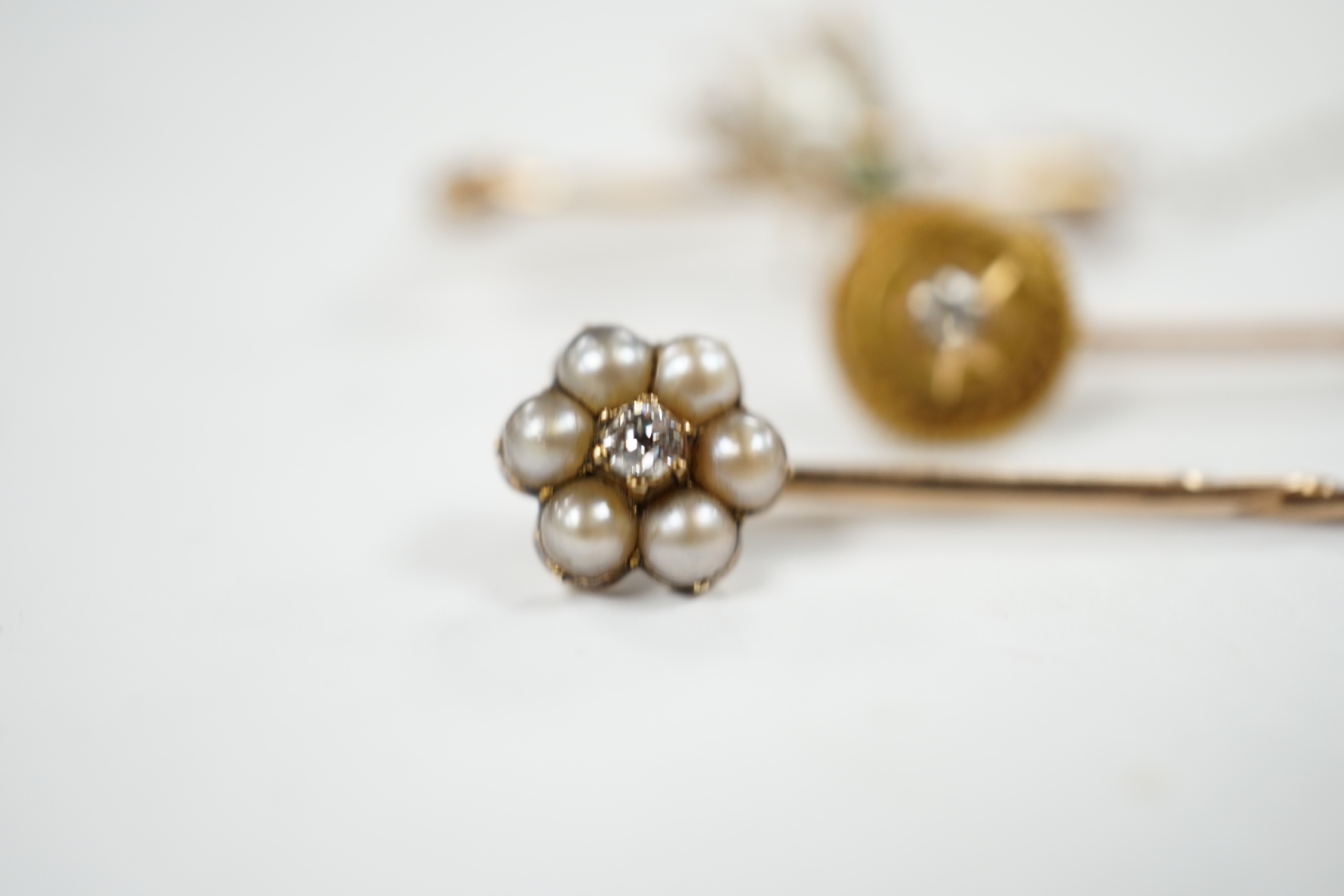 An early 20th century 9ct and gem set bug brooch, 34mm and two yellow metal stick pins, diamond and diamond and seed pearl set.
